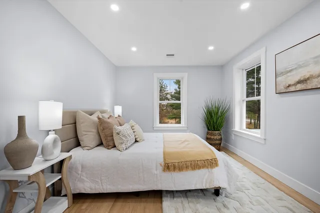 a bedroom with bed and window