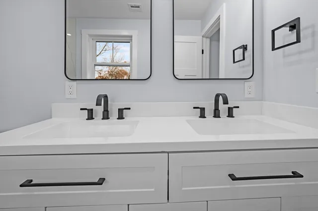 a bathroom with sink mirror and vanity