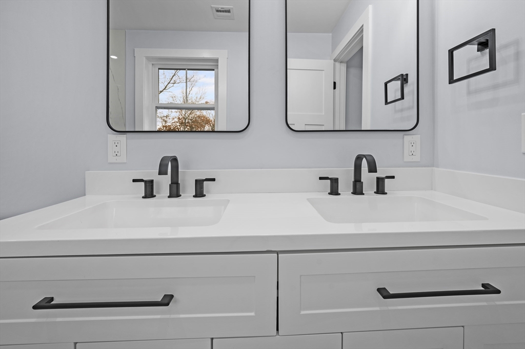 69 Readville Street, Unit B Boston, MA 02136 - Photo 21 of 38 a bathroom with sink mirror and vanity