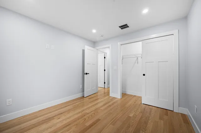 a view of hallway with wooden floor