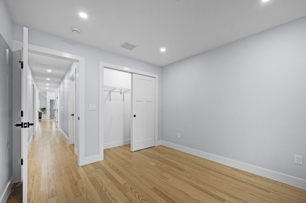 69 Readville Street, Unit B Boston, MA 02136 - Photo 25 of 38 a view of a hallway with wooden floor
