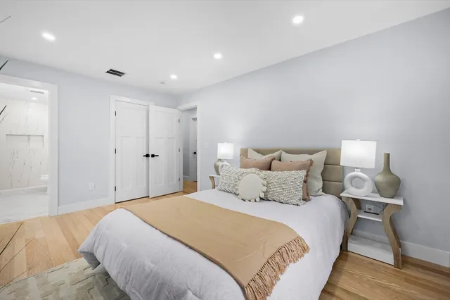 a bedroom with bed and a night stand