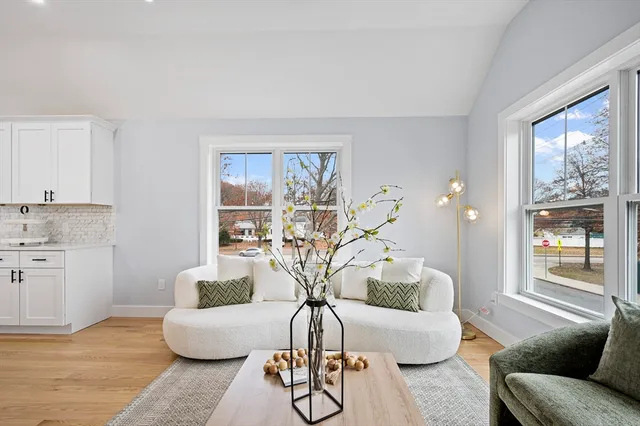 a living room with furniture and a large window
