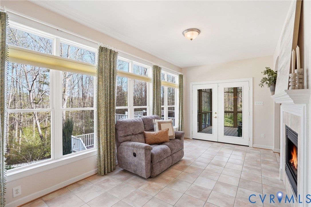 14430 Overlook Ridge Lane Beaverdam, VA 23015 - Photo 26 of 71 a living room with fireplace furniture and a floor to ceiling window