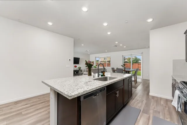 a kitchen with granite countertop a sink and cabinets