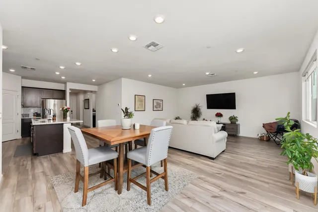 a dining room with furniture and wooden floor