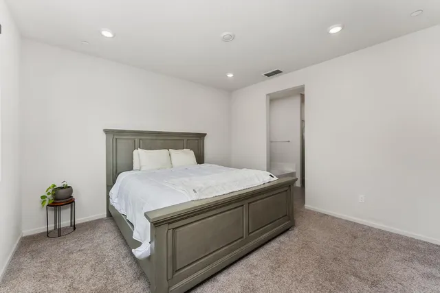 a bedroom with a bed and a lamp