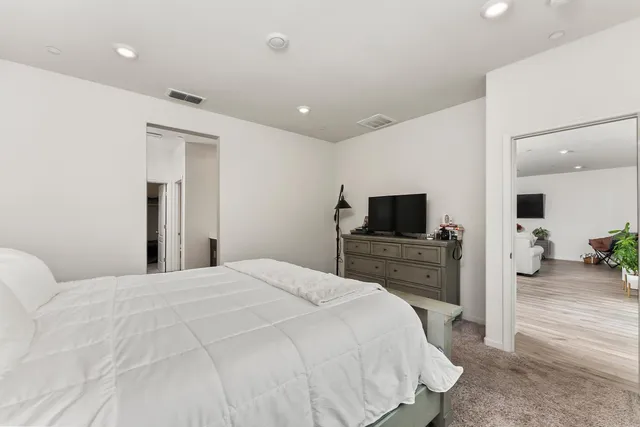 a bedroom with a bed and a flat screen tv