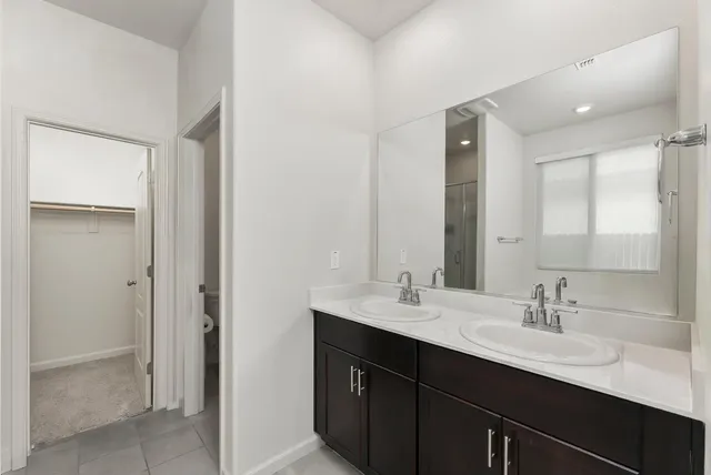 a bathroom with a double vanity sink a and mirror