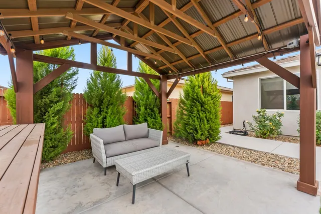 a view of patio with a table and chairs and potted plants