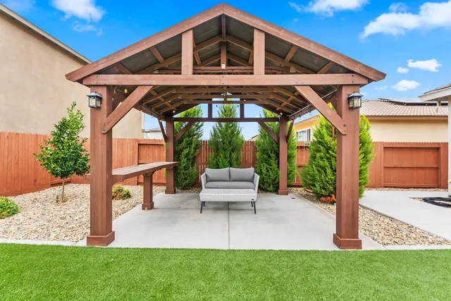 a patio with a table and chairs under an umbrella