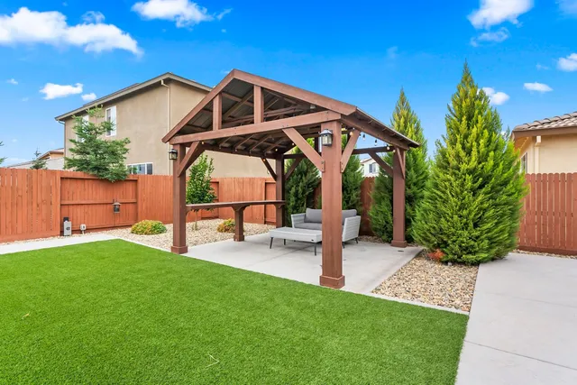 a view of a chair and table in the garden