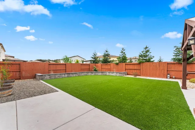 a view of an house with backyard space and sitting area
