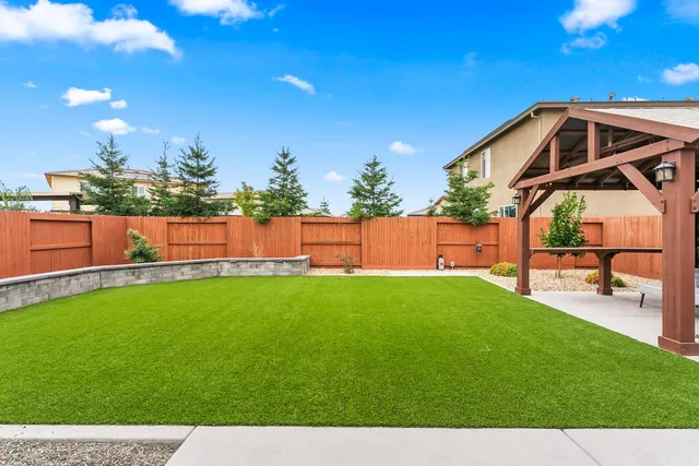 a view of a backyard with sitting area