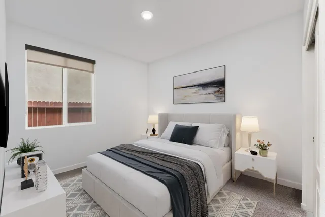 a bedroom with a bed and a window