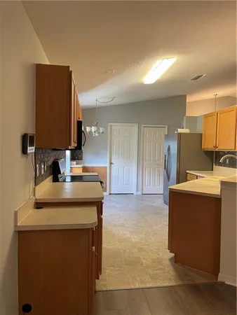 a kitchen with stainless steel appliances granite countertop a sink and a stove top oven