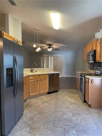 a kitchen with a sink stainless steel appliances and cabinets
