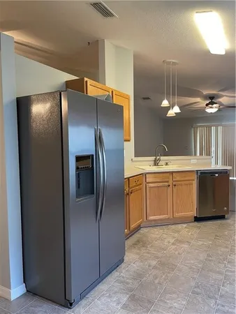 a kitchen with stainless steel appliances a refrigerator and a sink