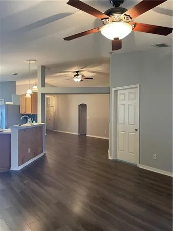 a view of a room with wooden floor and cabinet
