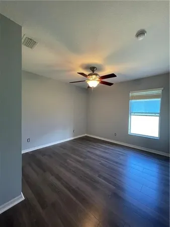 a view of a room with wooden floor and windows