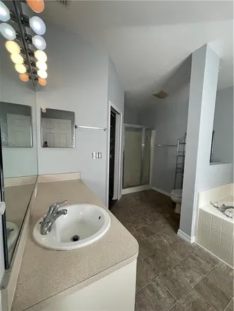 a bathroom with a sink a bathtub and a mirror