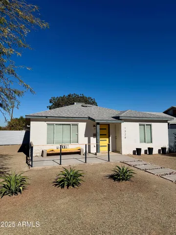 a view of a house with a backyard