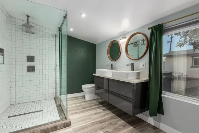 a bathroom with a sink mirror vanity and toilet