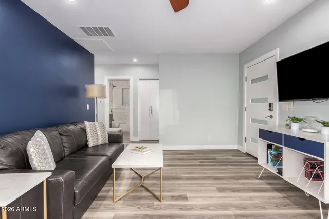 a living room with furniture and a flat screen tv