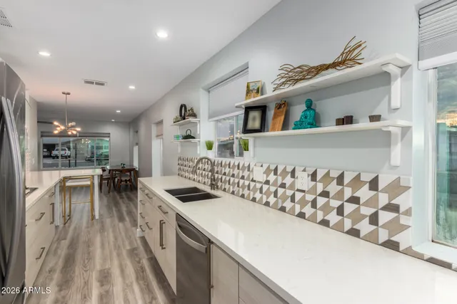 a kitchen with stainless steel appliances granite countertop a sink and cabinets