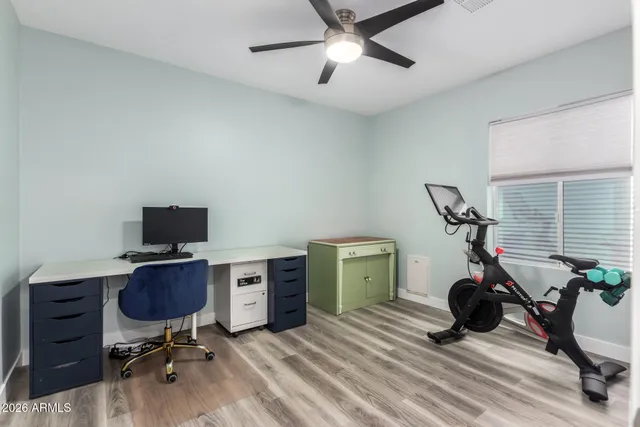 a view of a workspace with furniture and a window
