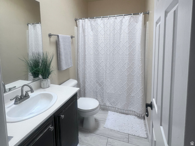 2815 Gordon Creek Road Price, UT 84501 - Photo 6 of 13 Bathroom featuring a vanity with a white countertop, undermount sink, and dark cabinetry