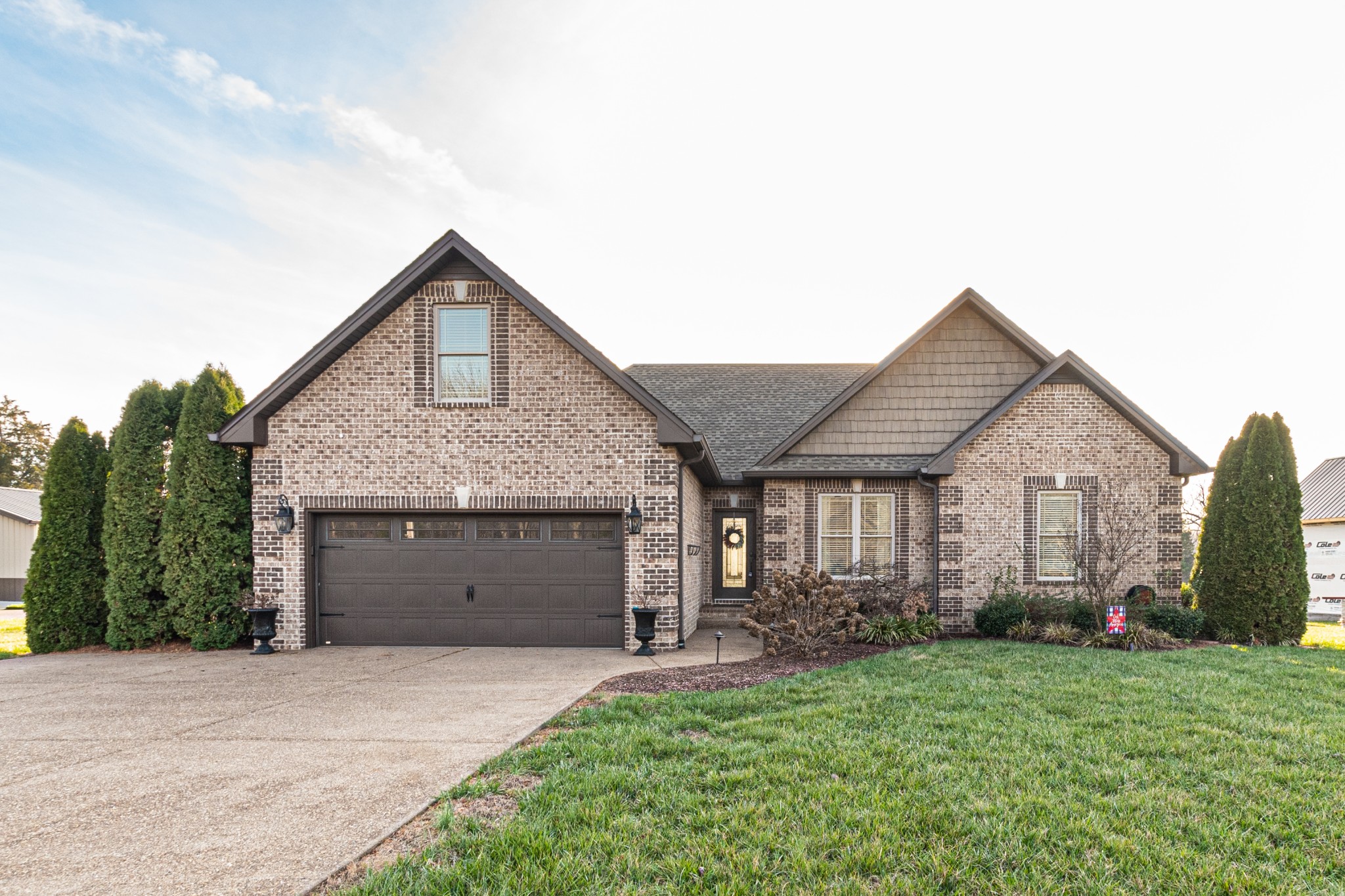 858 Coker Ford Road Portland, TN 37148 - Photo 1 of 30 a front view of a house with a garden and garage