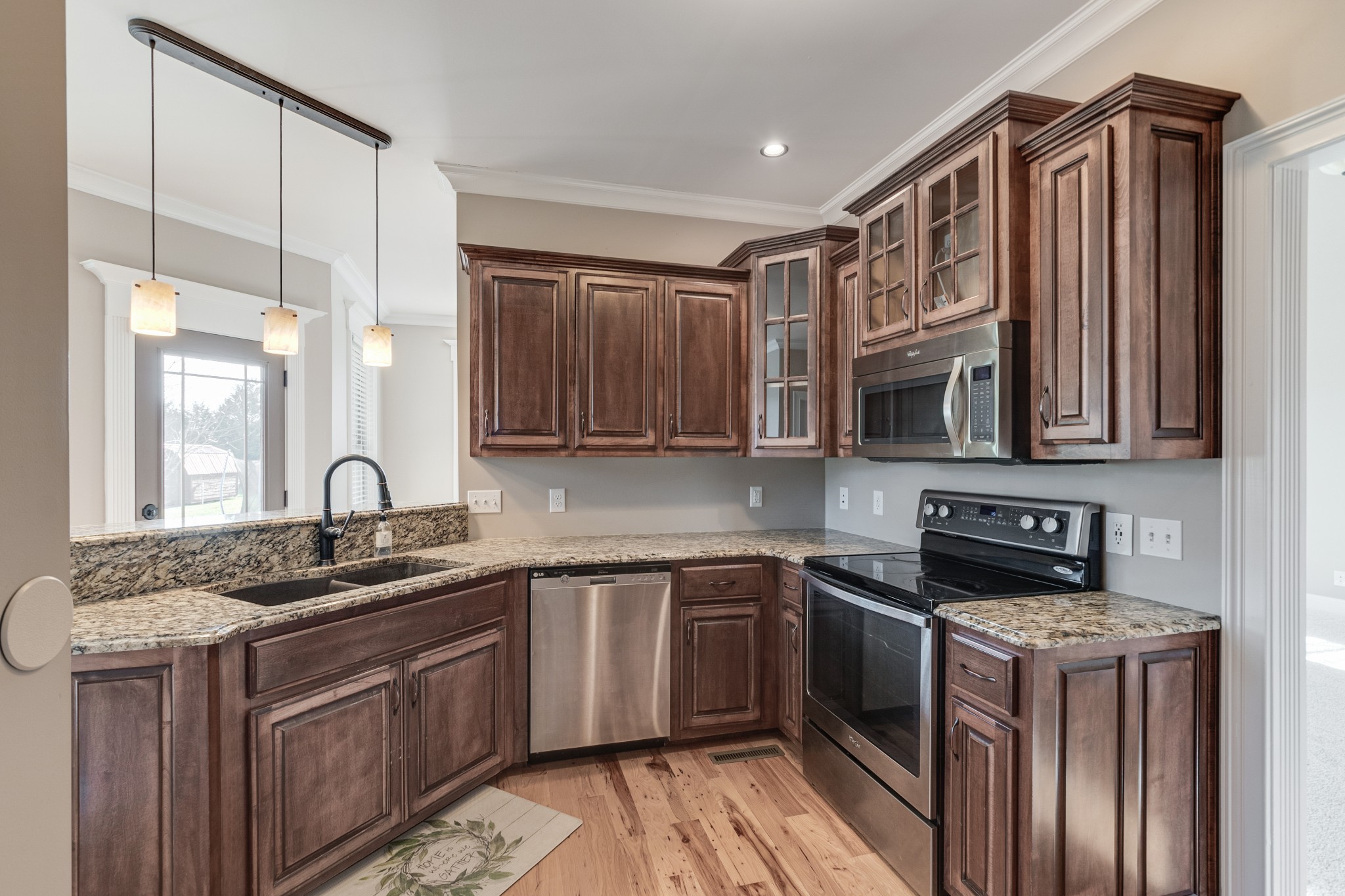 858 Coker Ford Road Portland, TN 37148 - Photo 11 of 30 a kitchen with stainless steel appliances granite countertop a sink stove and cabinets