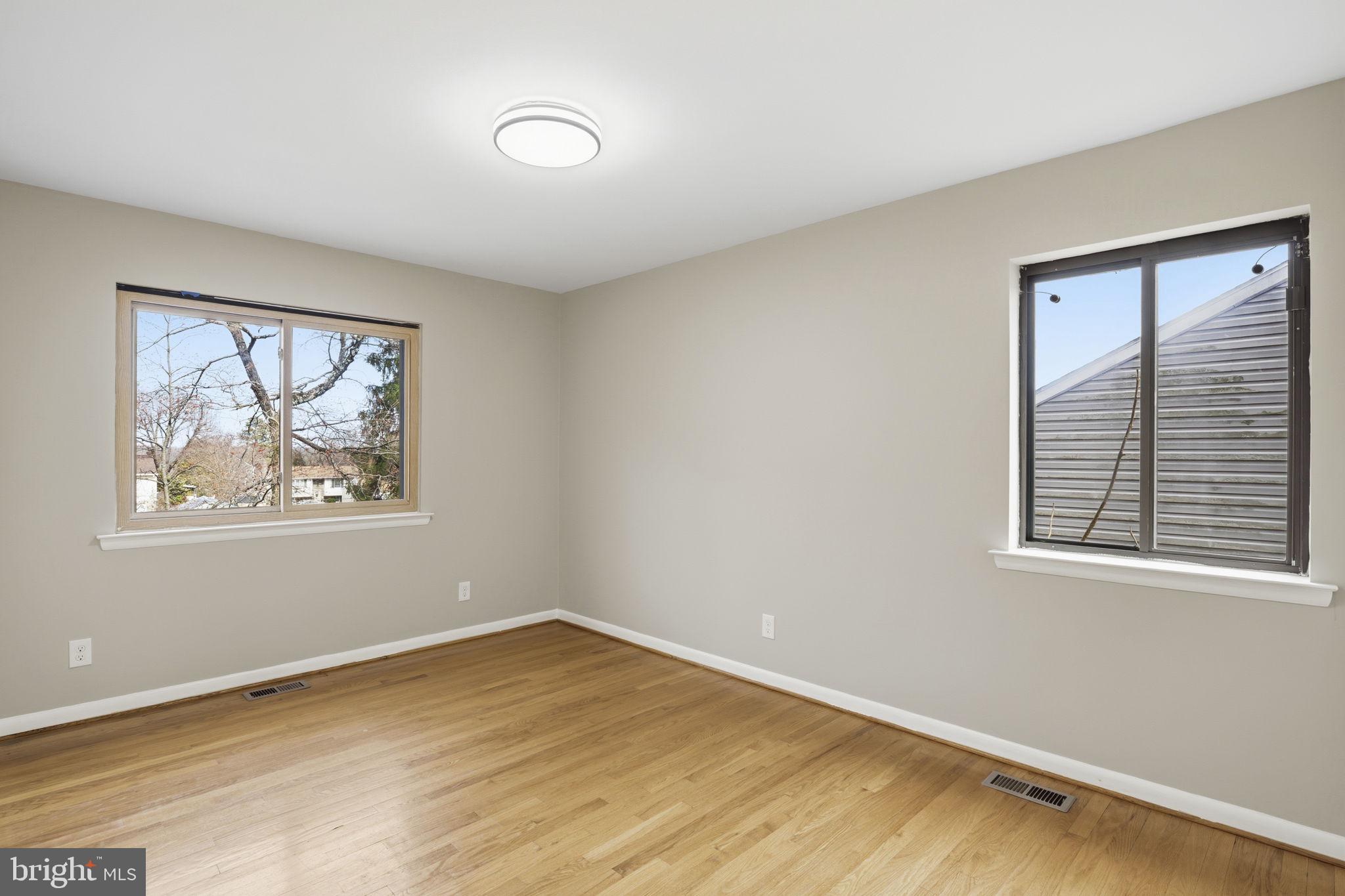 2815 Northwind Road Parkville, MD 21234 - Photo 14 of 21 a view of an empty room with a window and wooden floor