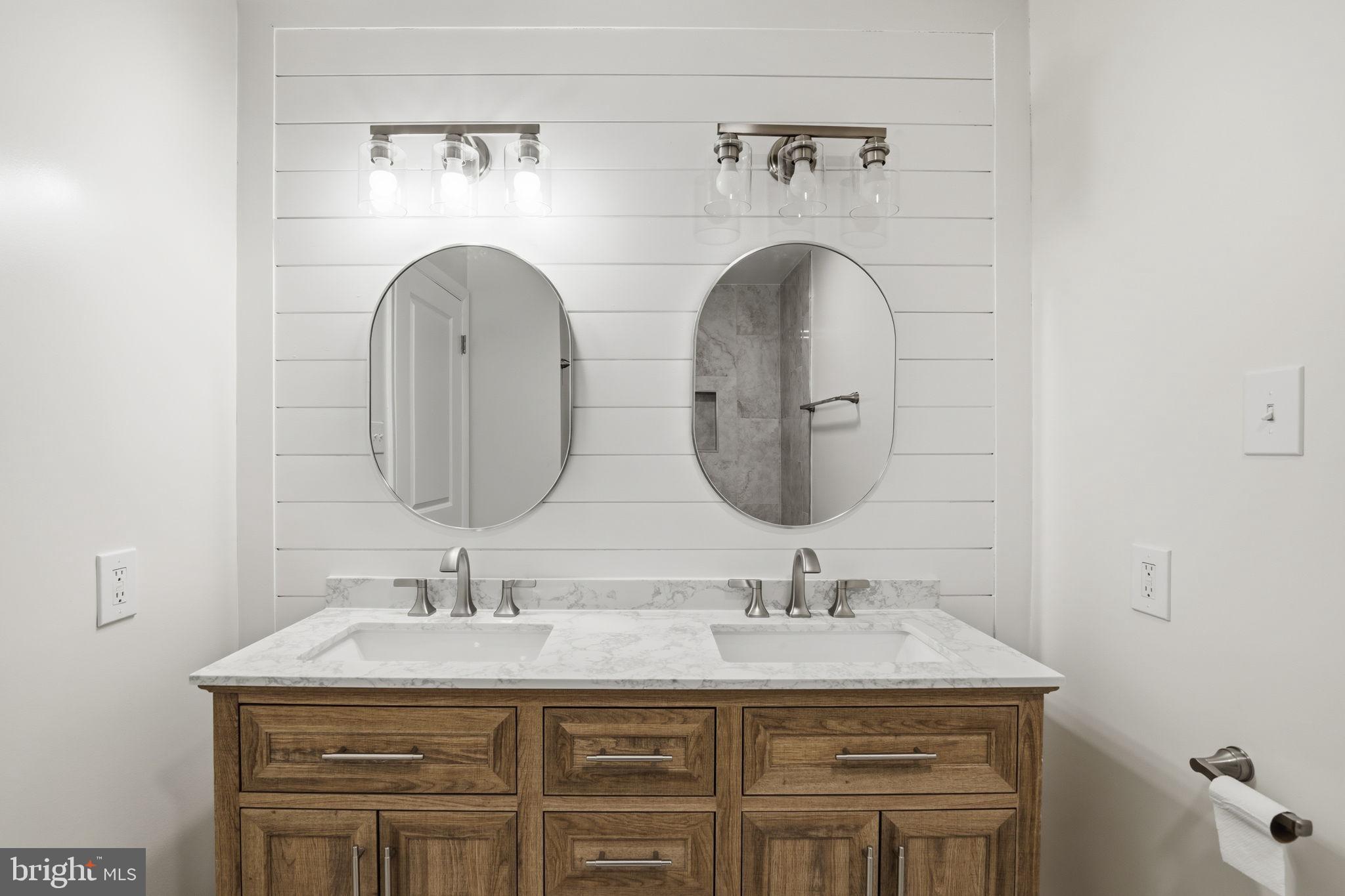 2815 Northwind Road Parkville, MD 21234 - Photo 16 of 21 a bathroom with a granite countertop sink a mirror and vanity