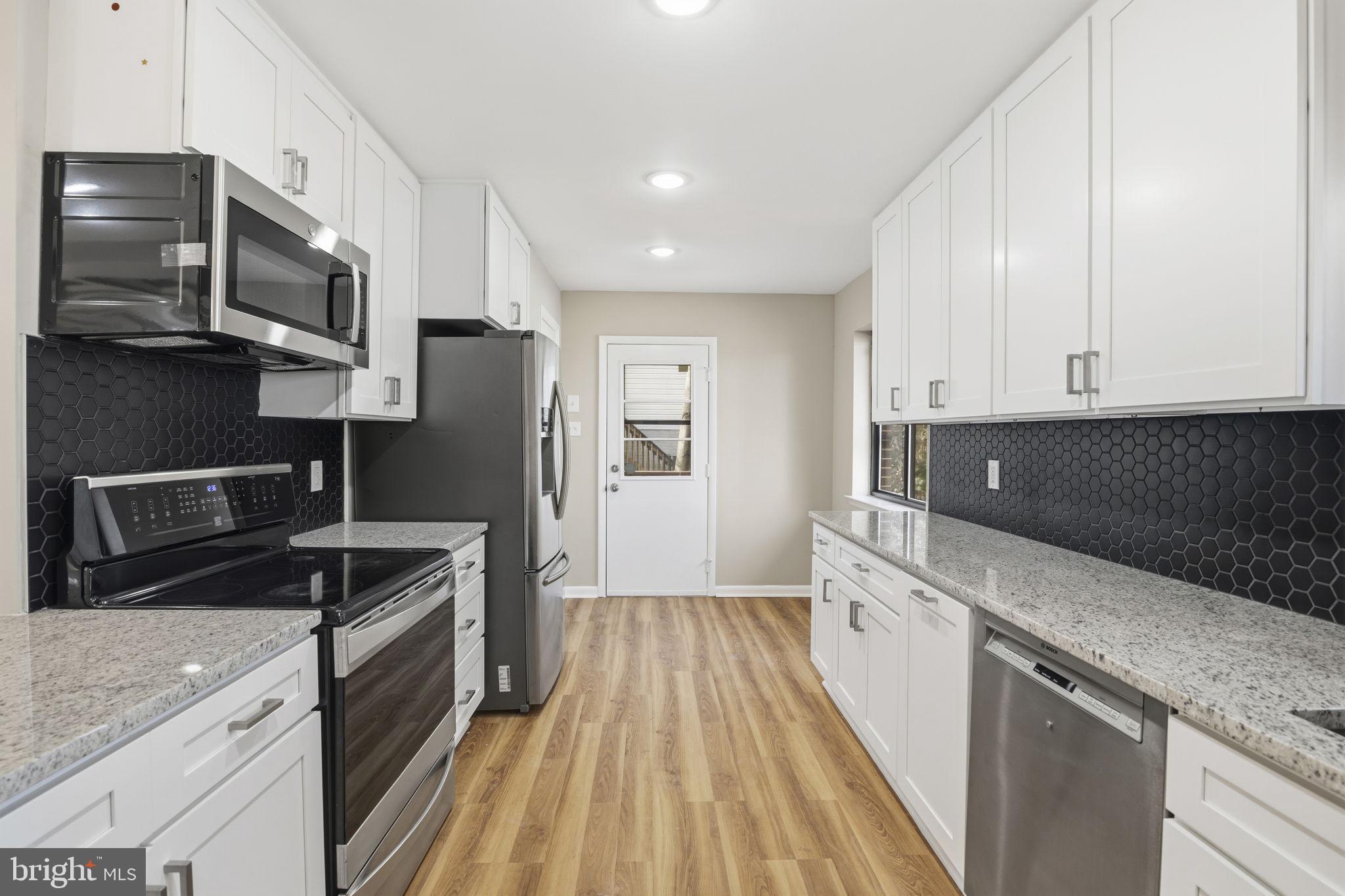 2815 Northwind Road Parkville, MD 21234 - Photo 6 of 21 a kitchen with stainless steel appliances granite countertop a sink stove and microwave