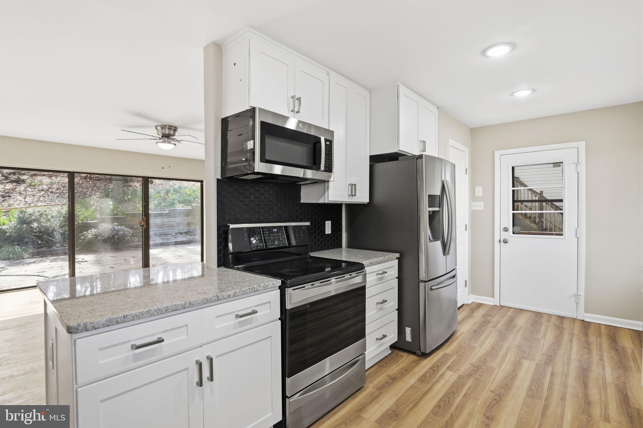 2815 Northwind Road Parkville, MD 21234 - Photo 8 of 21 a kitchen with stainless steel appliances a refrigerator stove and microwave