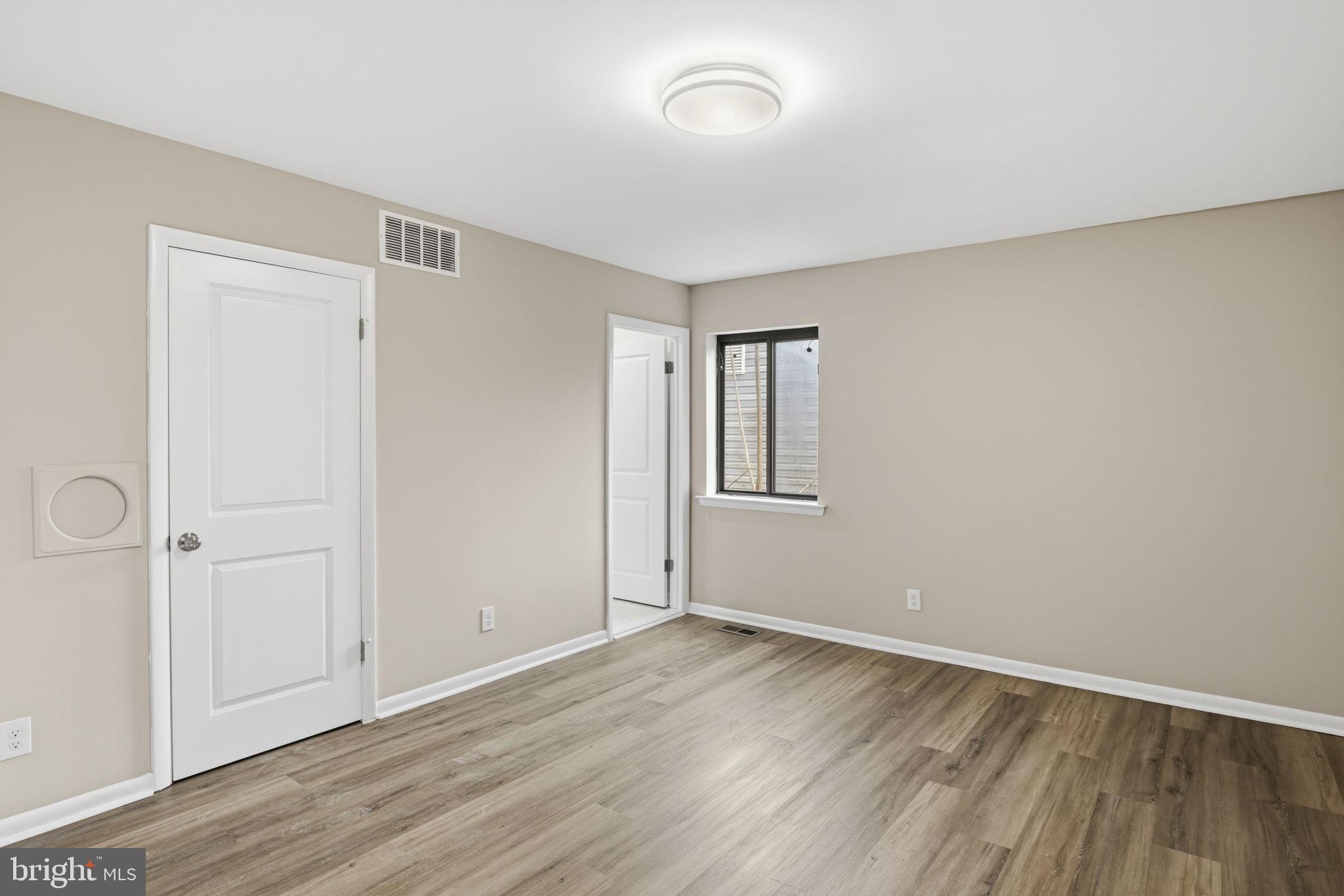 2815 Northwind Road Parkville, MD 21234 - Photo 10 of 21 an empty room with wooden floor and windows