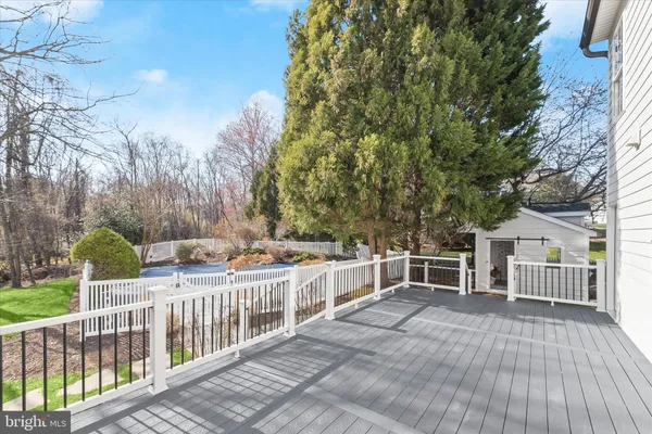 a view of a yard with wooden fence