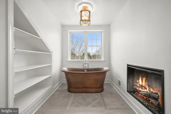 a spacious bathroom with a granite countertop sink a mirror and bathtub