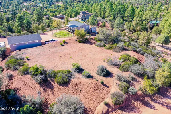 a backyard of a house with a yard and outdoor seating
