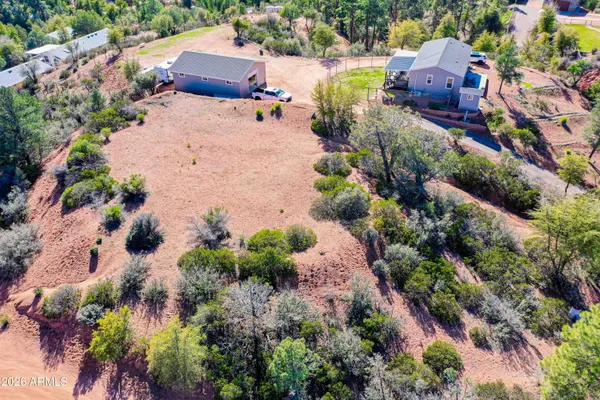 an aerial view of a house with a yard and a wooden fence