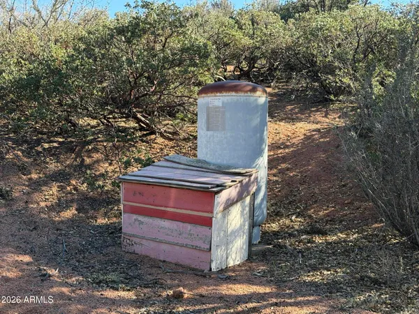 a wooden bench sitting in the middle of a yard
