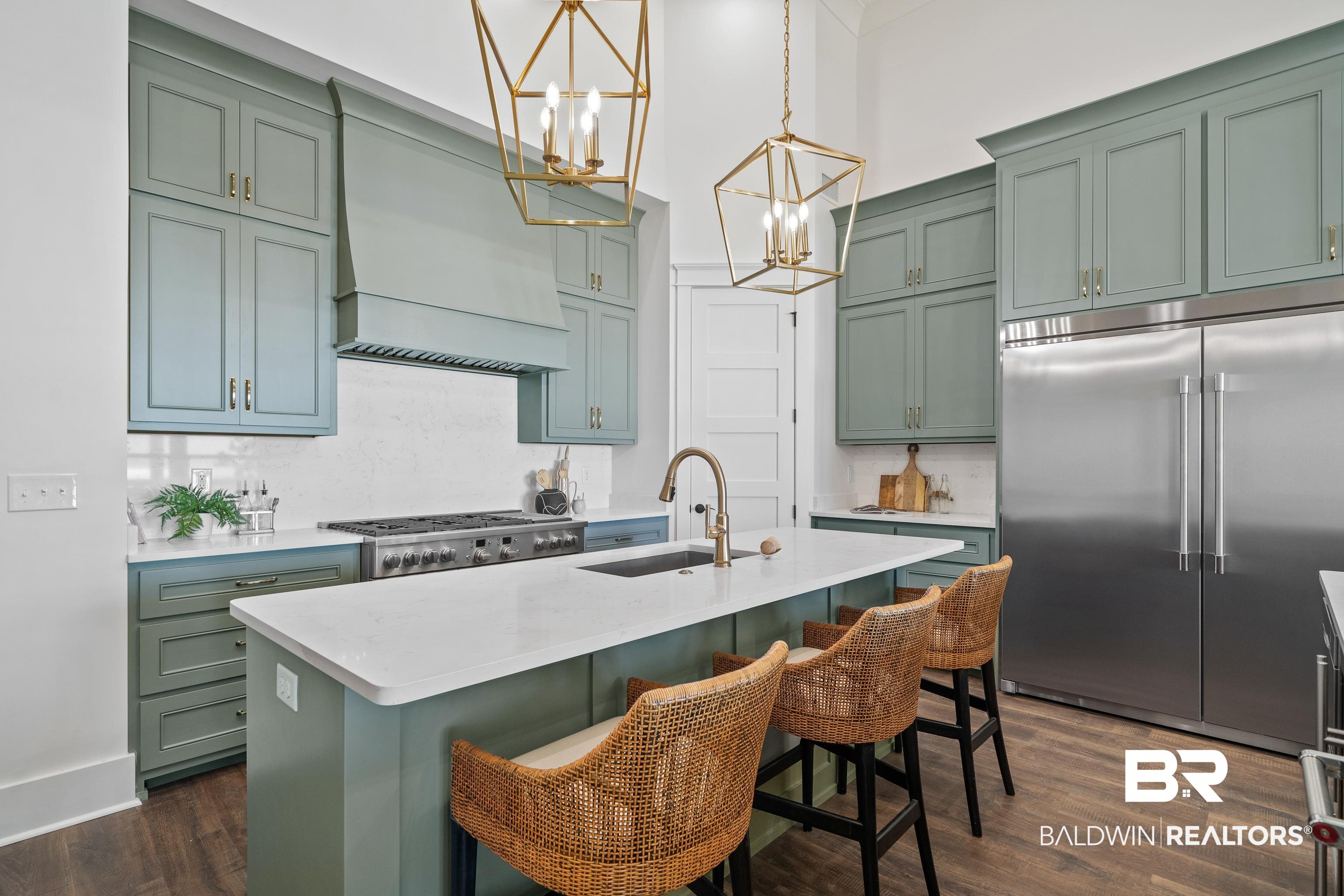 12453 County Road 1 Fairhope, AL 36532 - Photo 5 of 33 Kitchen with a center island with sink, dark hardwood / wood-style floors, sink, and appliances with stainless steel finishes