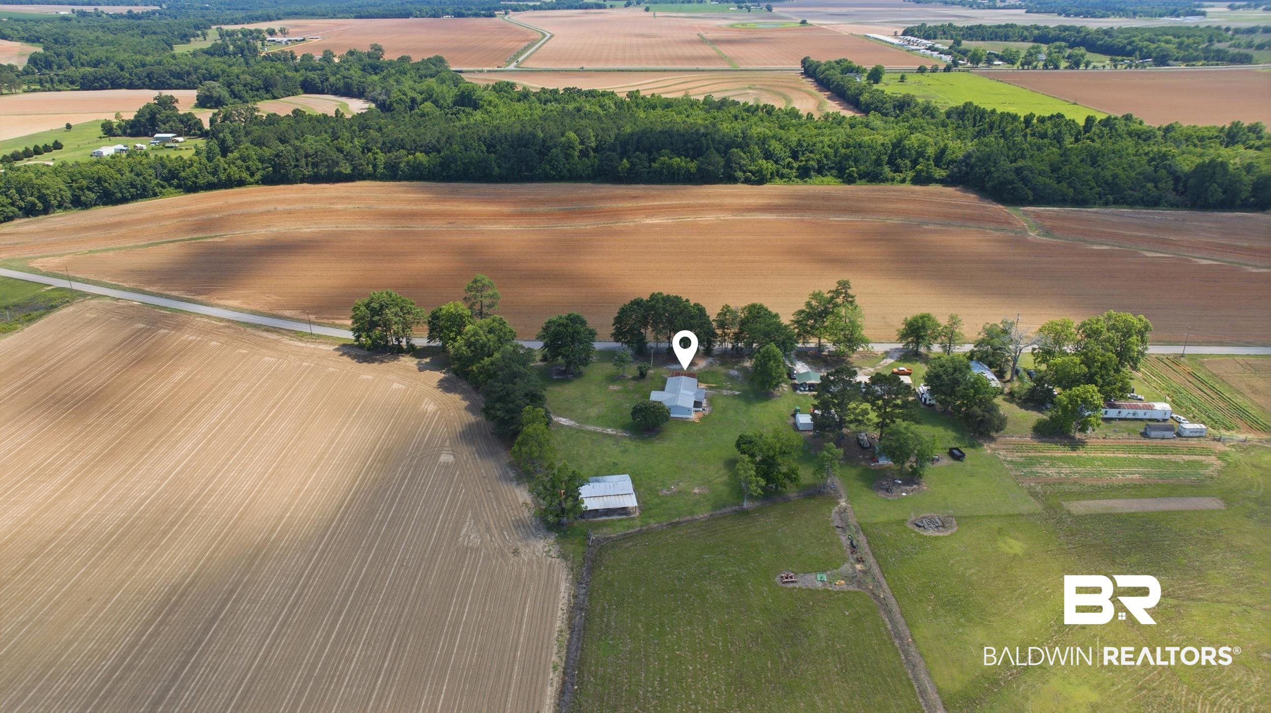 926 Tumbling Lane Atmore, AL 36502 - Photo 55 of 56 Aerial perspective featuring a central dwelling surrounded by mature trees and expansive agricultural fields