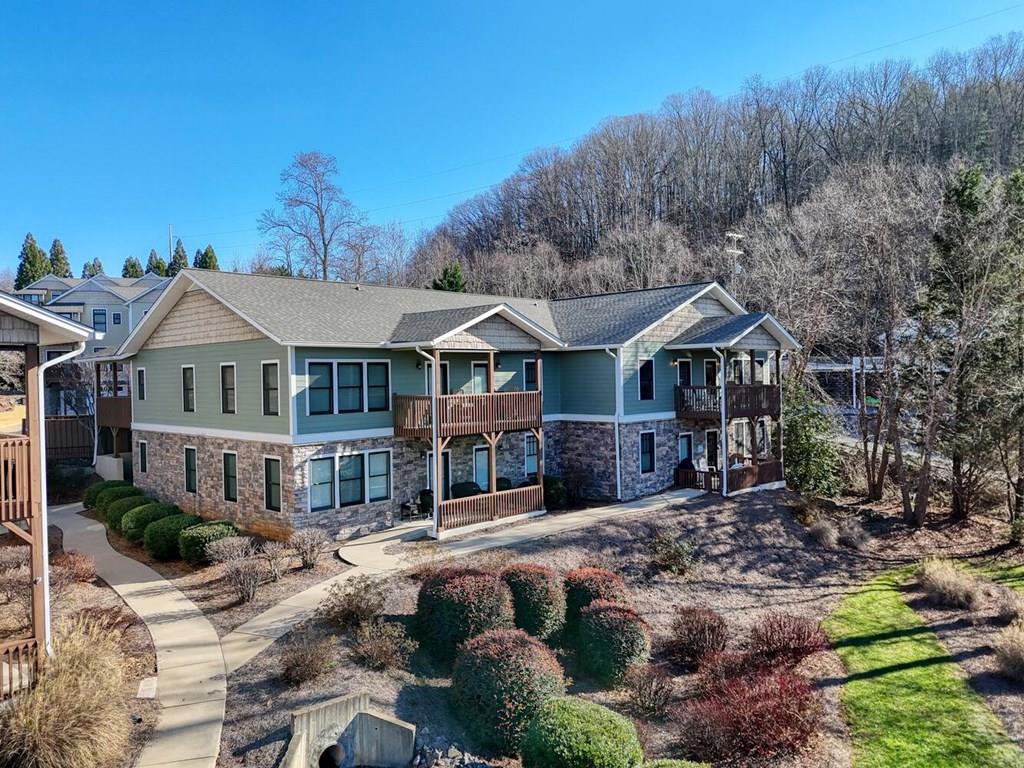 a front view of a residential houses with yard and mountain view in back