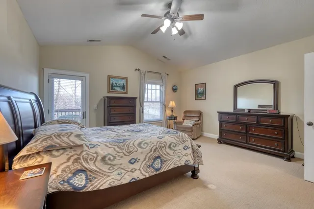 a bedroom with a bed and a dresser with mirror