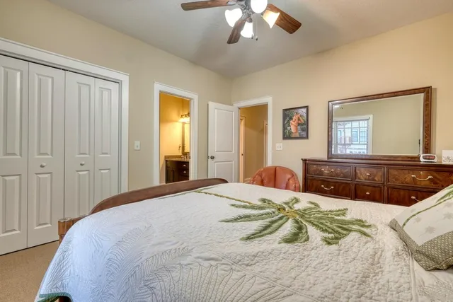 a bedroom with a large bed and a chandelier