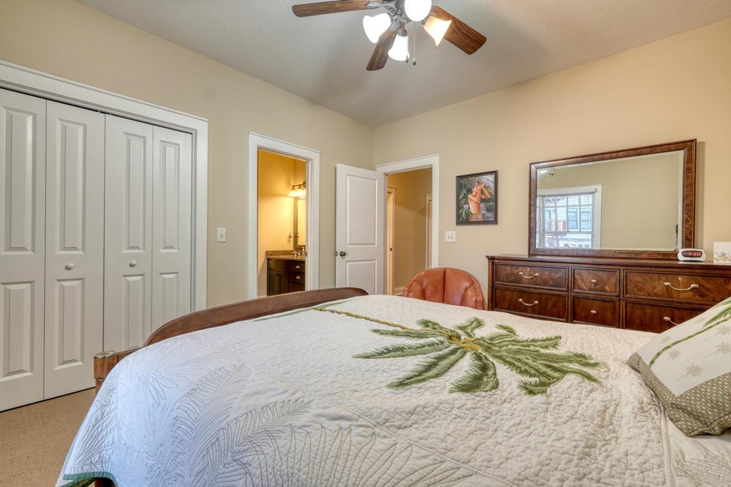 1405 Lakeside Road Hiawassee, GA 30546 - Photo 18 of 37 a bedroom with a large bed and a chandelier