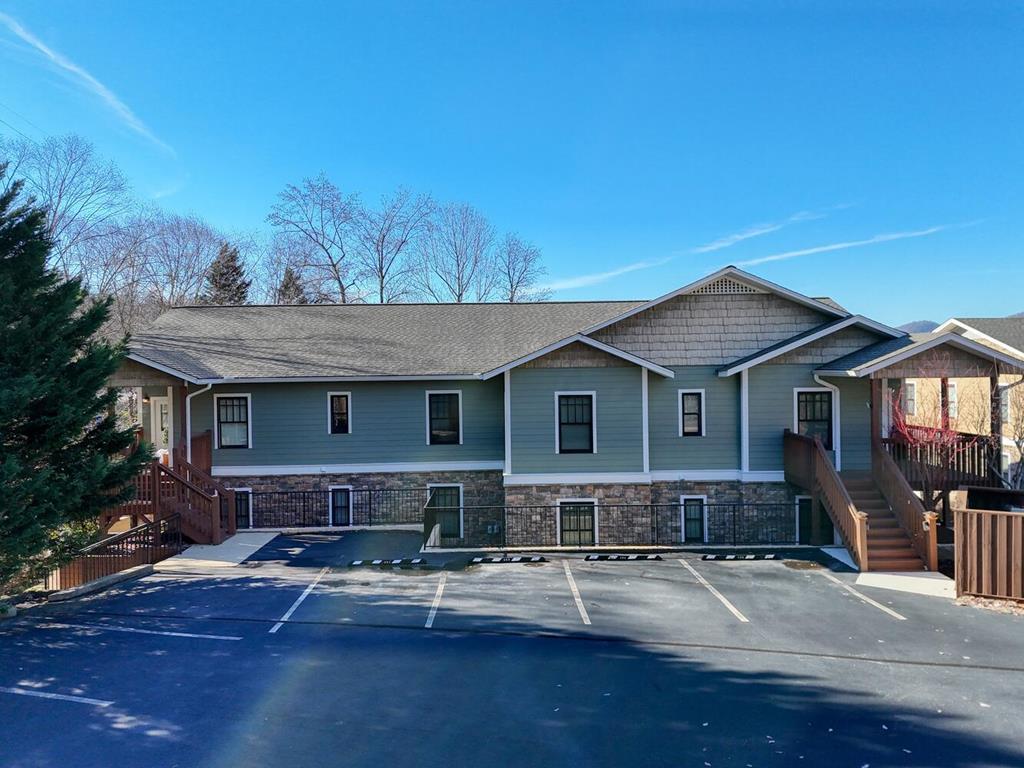 1405 Lakeside Road Hiawassee, GA 30546 - Photo 2 of 37 a front view of a house with yard and trees